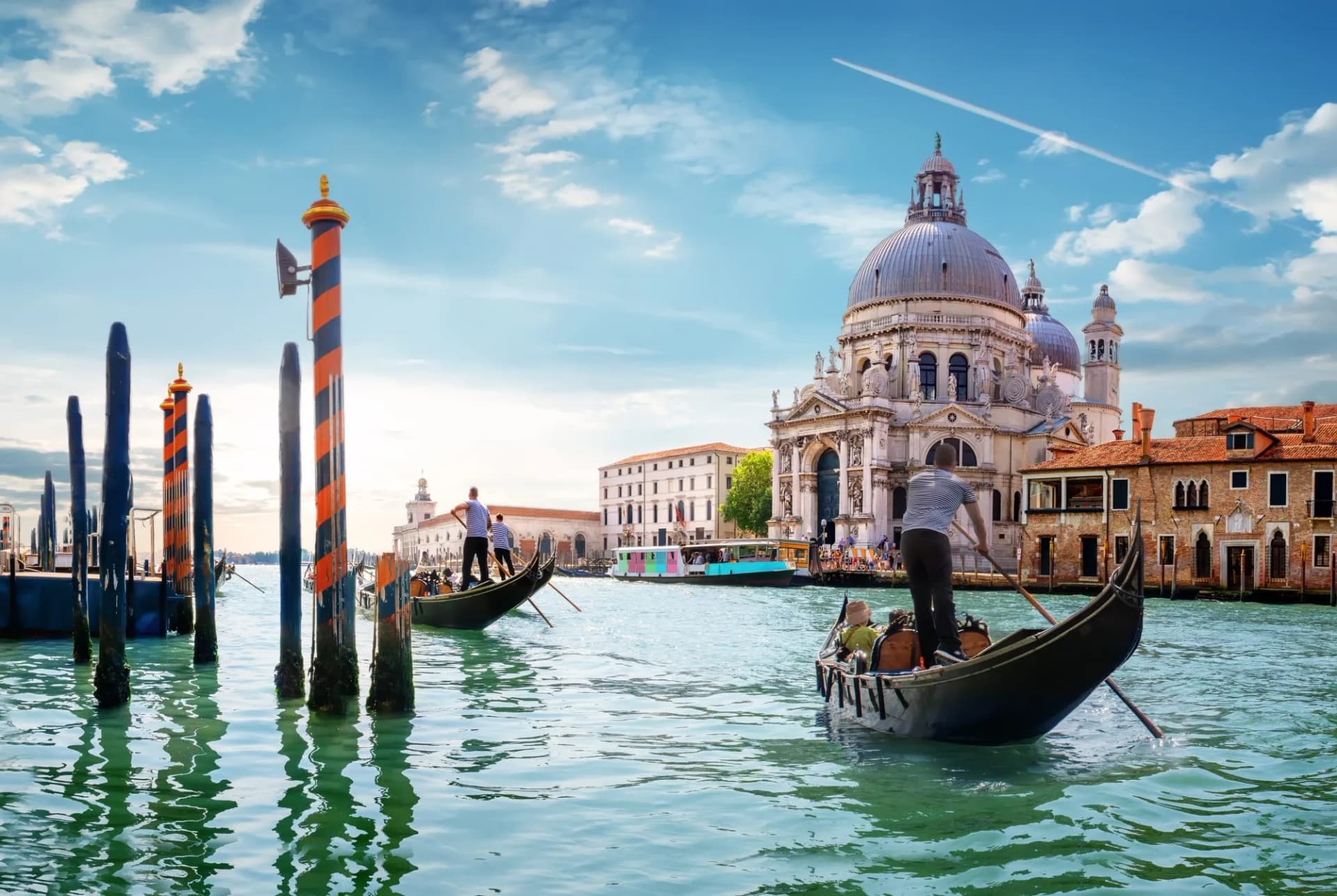 Gondolas on canal with Santa Maria della Salute church in Venice, Italy