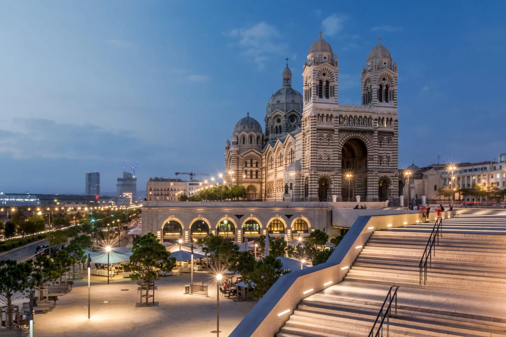 Cathédrale de la Major illuminated at dusk with modern plaza steps in Marseille