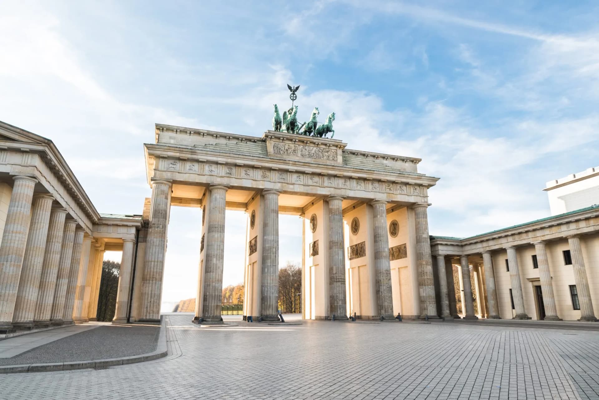 Brandenburg Gate with Quadriga statue under a bright blue sky in Berlin