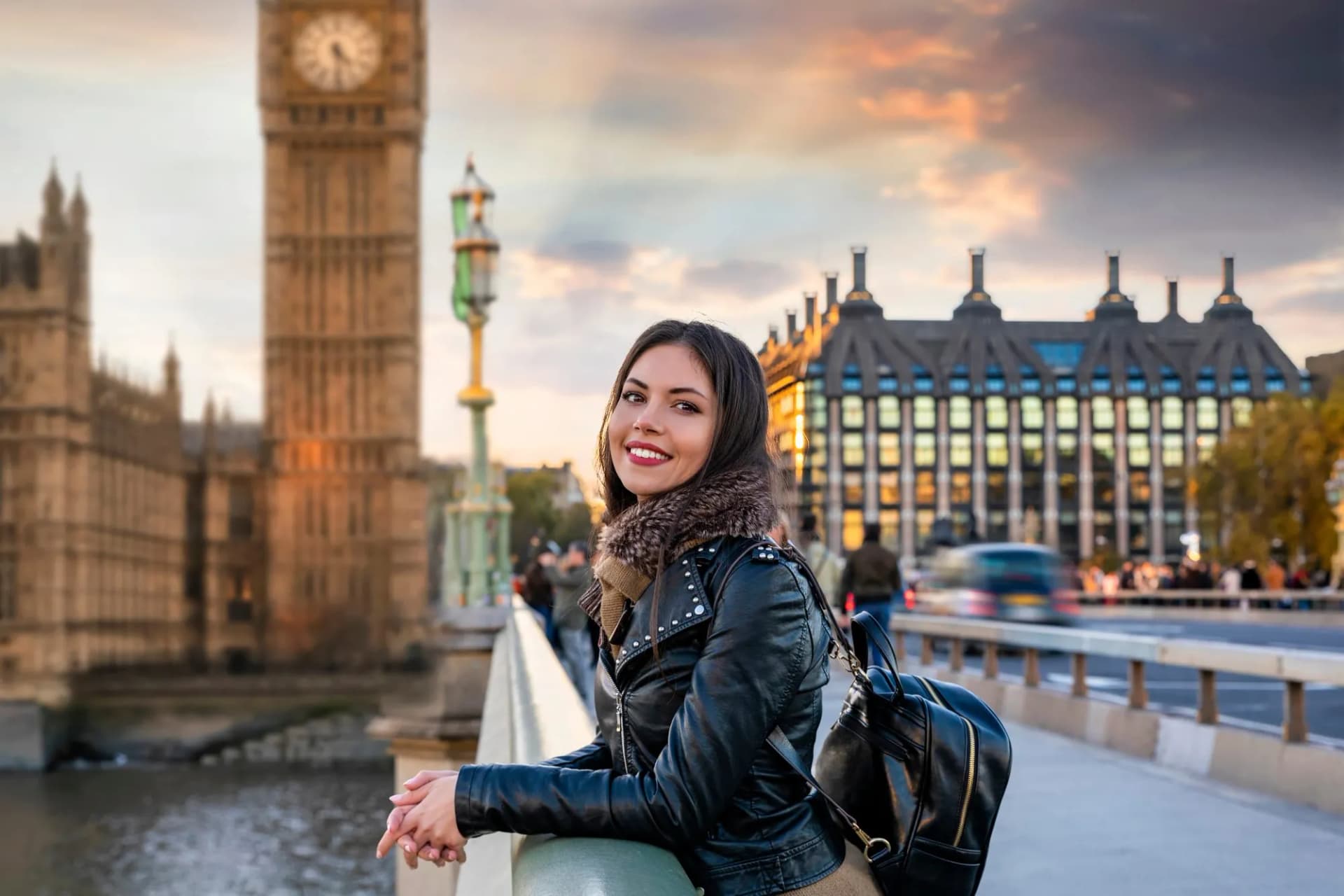 Tourist smiling on bridge with Big Ben and London buildings in background