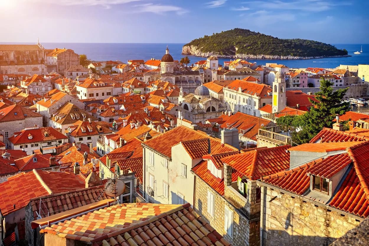 Rooftops of Dubrovnik with orange tiles overlooking the Adriatic Sea and Lokrum Island.