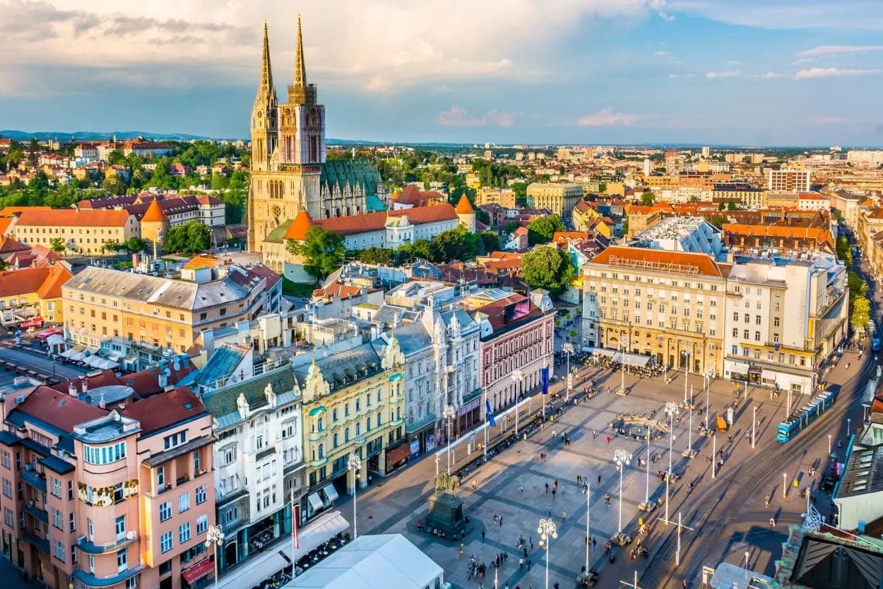 Zagreb panorama showing the Cathedral and Ban Jelačić Square with tram traffic.