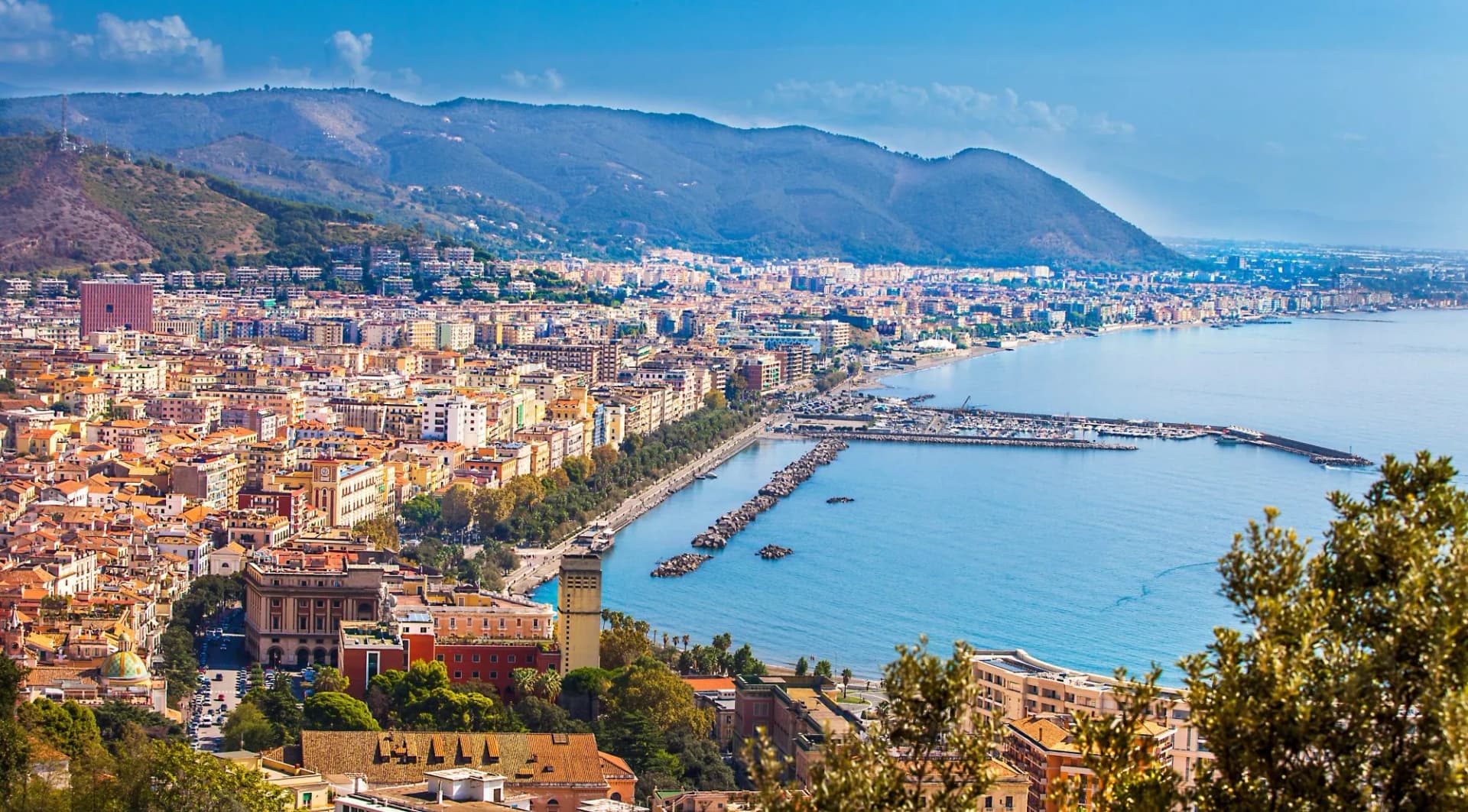 View of Salerno city and harbor nestled against mountains bordering the Gulf of Salerno, Campania, Italy.