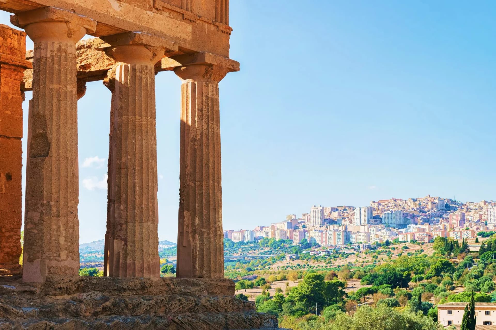 Fragment of the Temple of Concordia columns overlooking the modern city in Agrigento, Sicily.