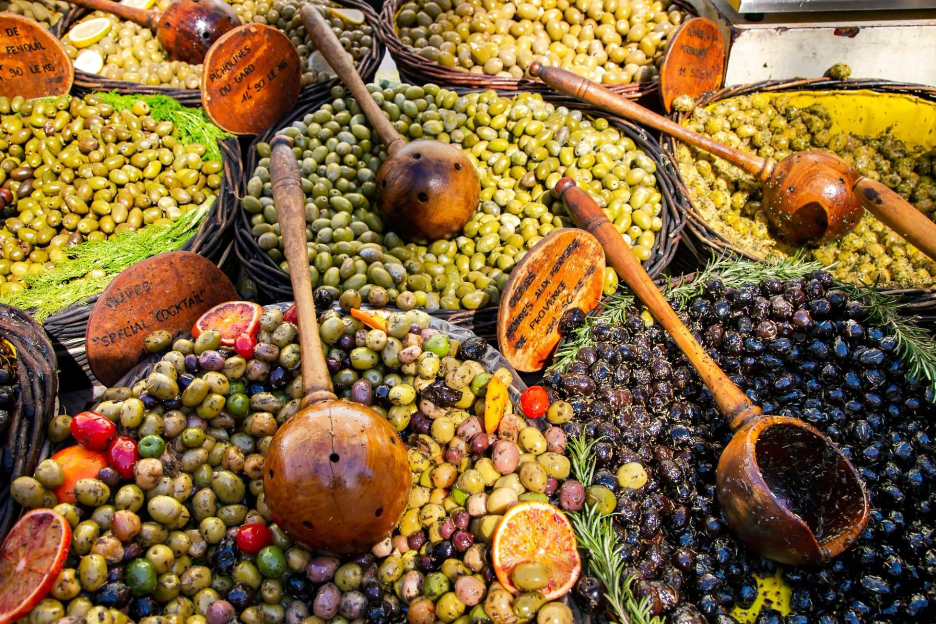 Colorful organic olives displayed at a farmers street market stall in Avignon, France.