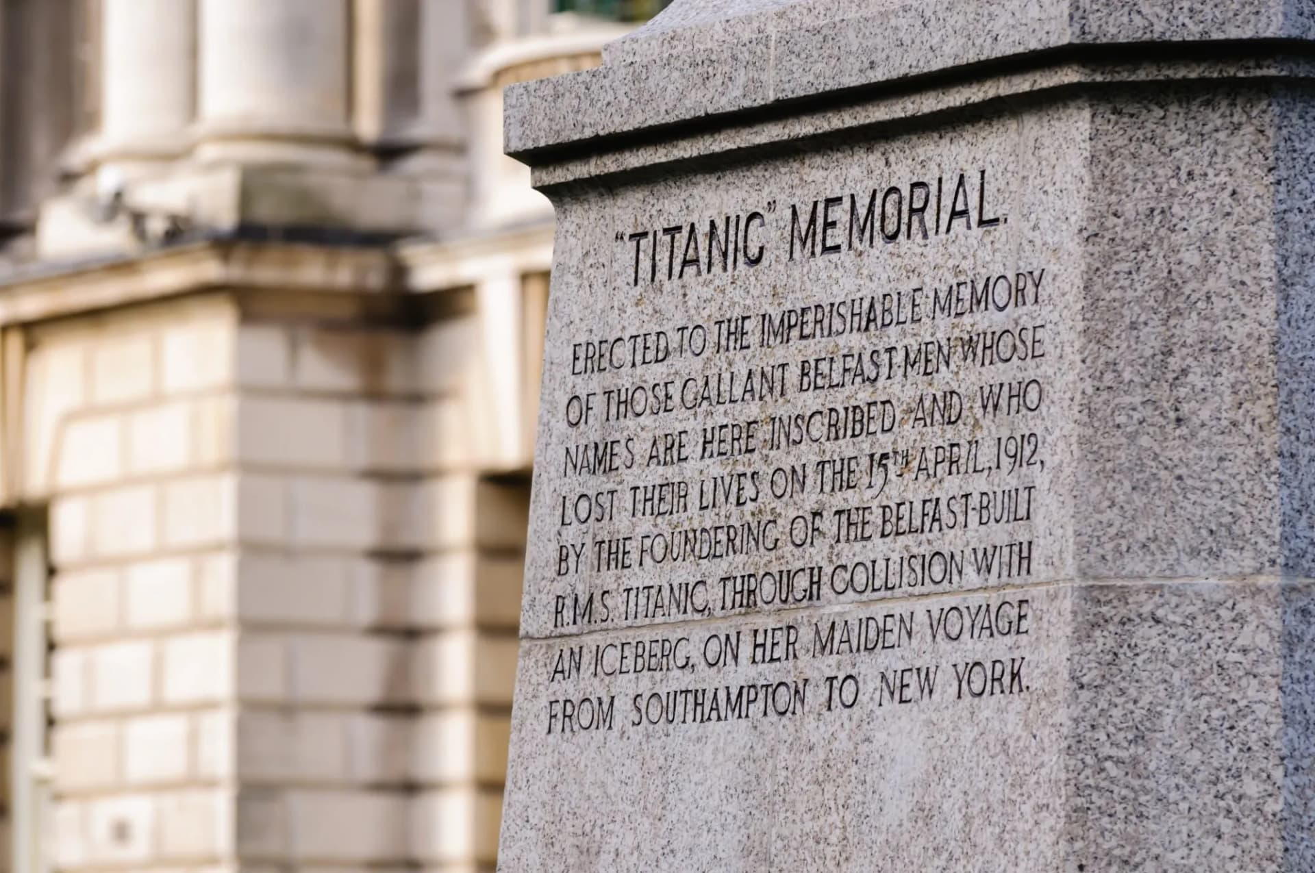 Titanic Memorial inscription on granite pedestal at Belfast City Hall garden.