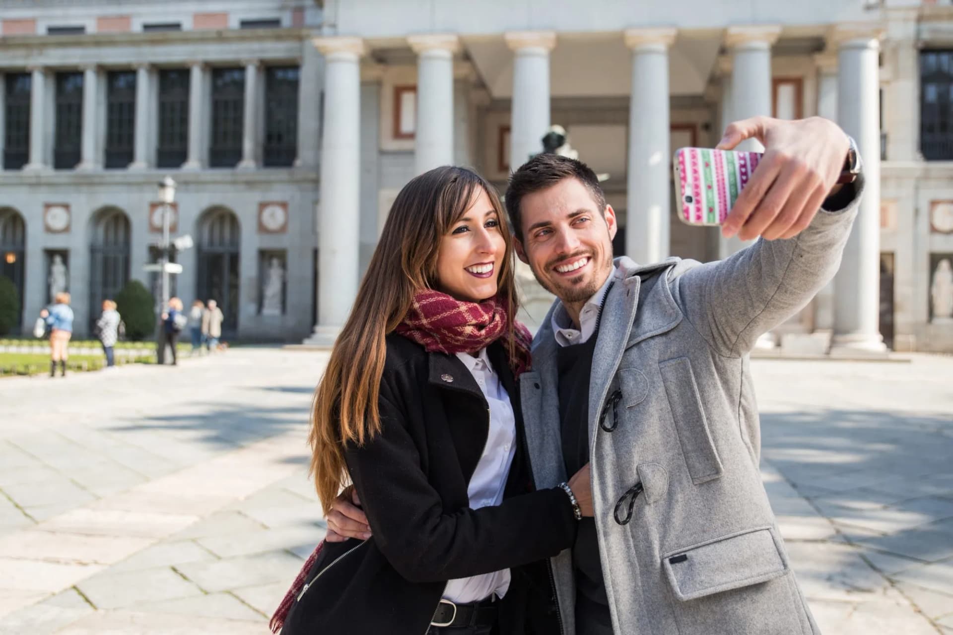 Couple taking a selfie with a smartphone outside the Prado Museum in Madrid