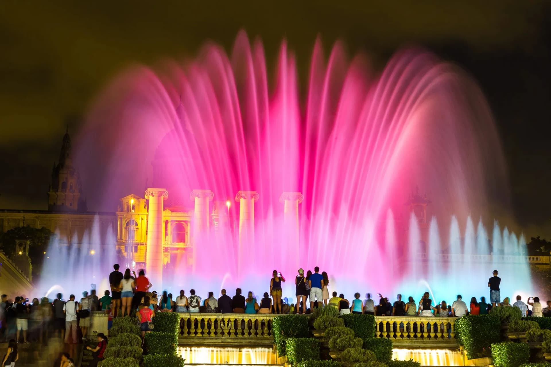 Magic Fountain light show with pink and blue water jets in Barcelona at night.