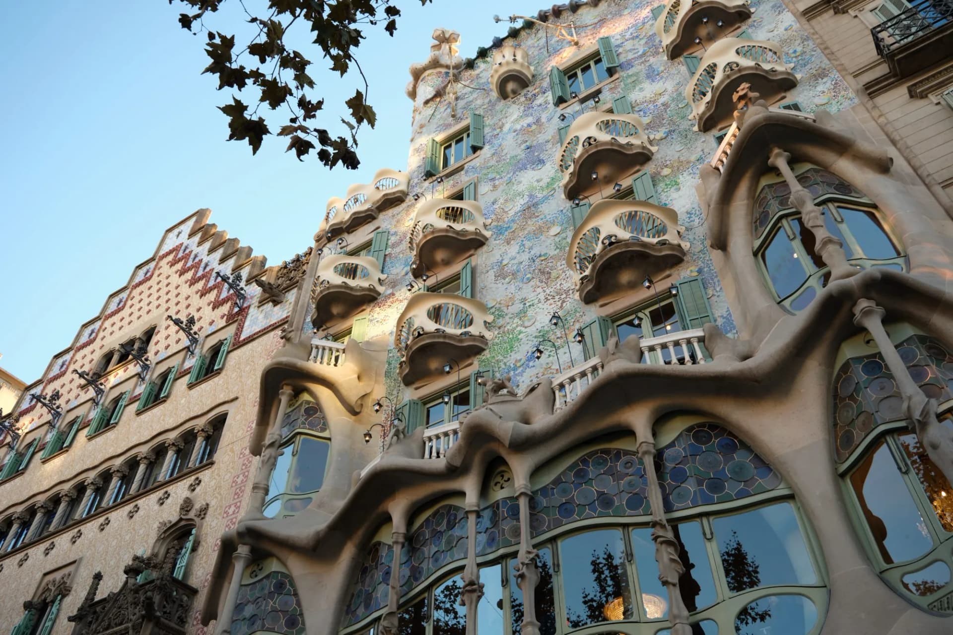 Casa Batlló building facade with organic forms and colorful mosaic in Barcelona, Catalonia, Spain.