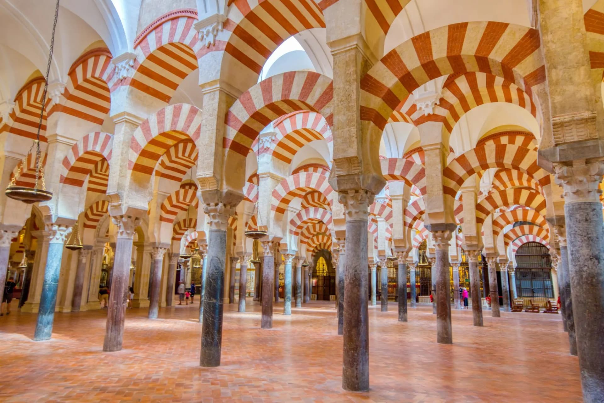 Interior vaulted ceiling of the Mezquita Cathedral, Cordoba, with red and white striped horseshoe arches.