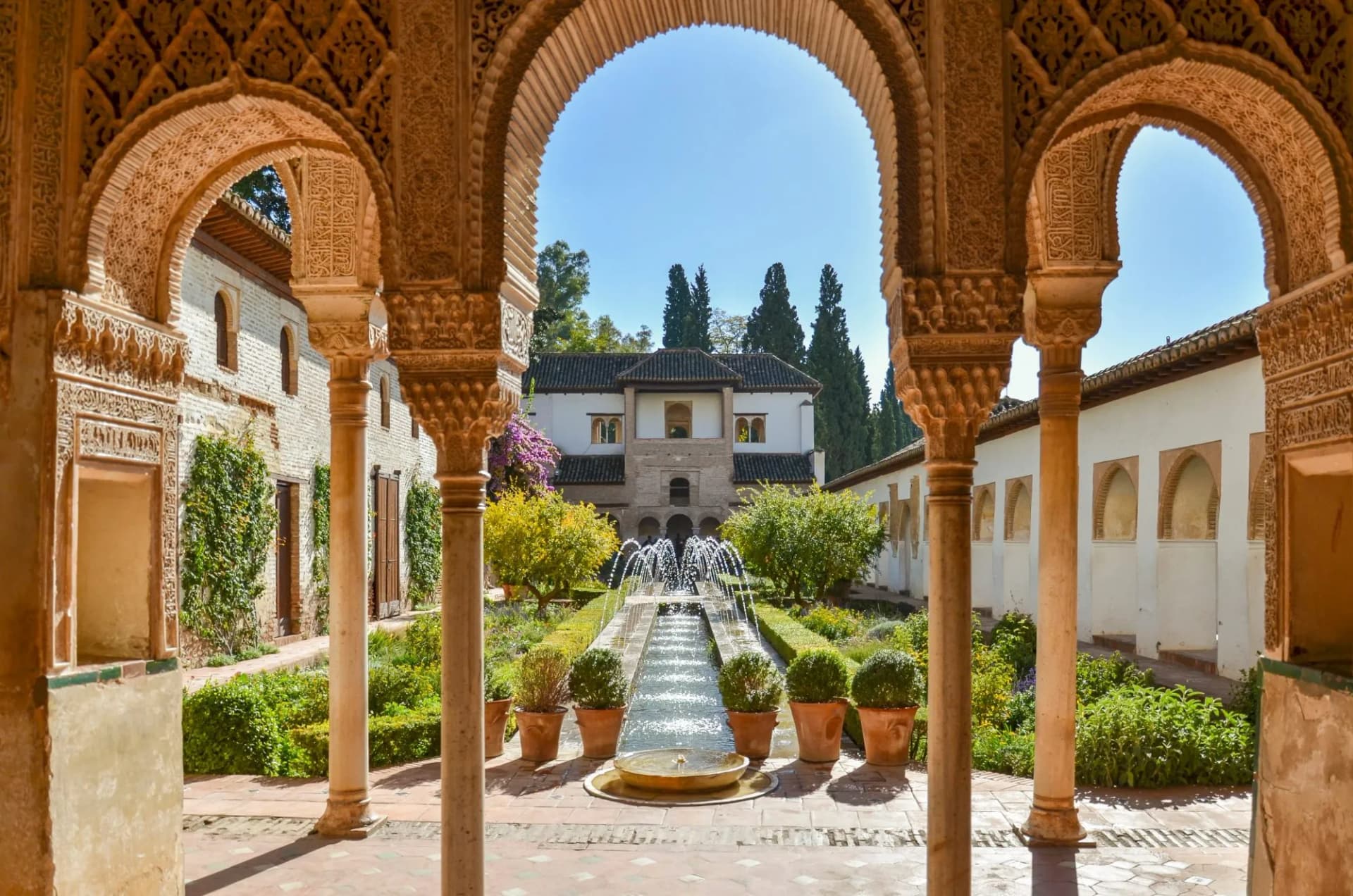 Palacio de Generalife Alhambra Granada Spain courtyard with fountain and ornate arches.
