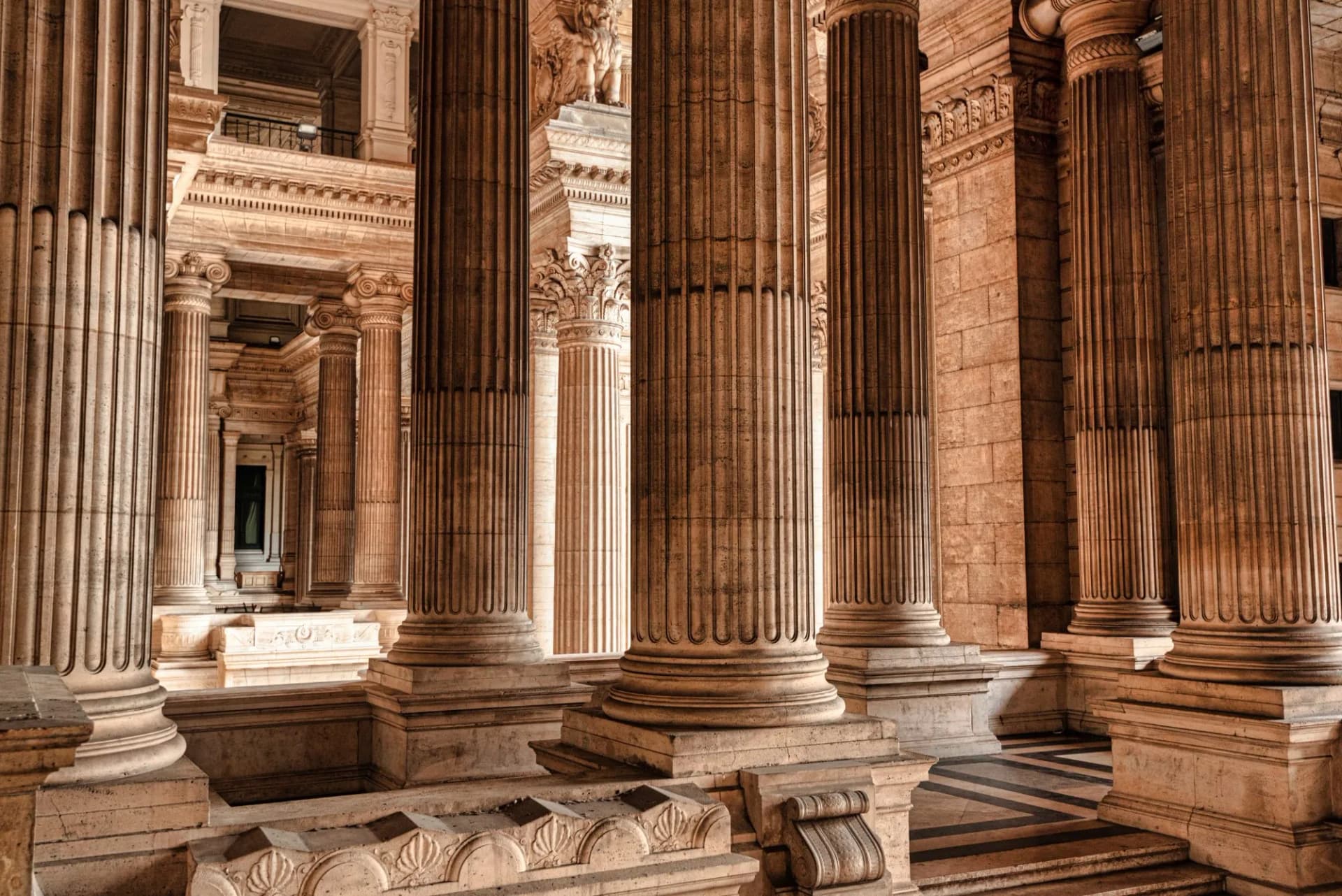 Interior view of massive fluted columns and neoclassical architecture inside the Palace of Justice, Brussels.