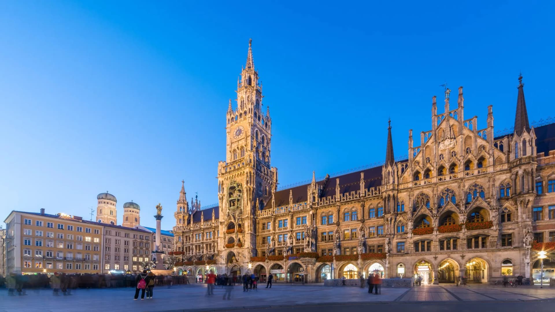 New Town Hall and Frauenkirche towers illuminated at night in Marienplatz, Munich, Bavaria, Germany.