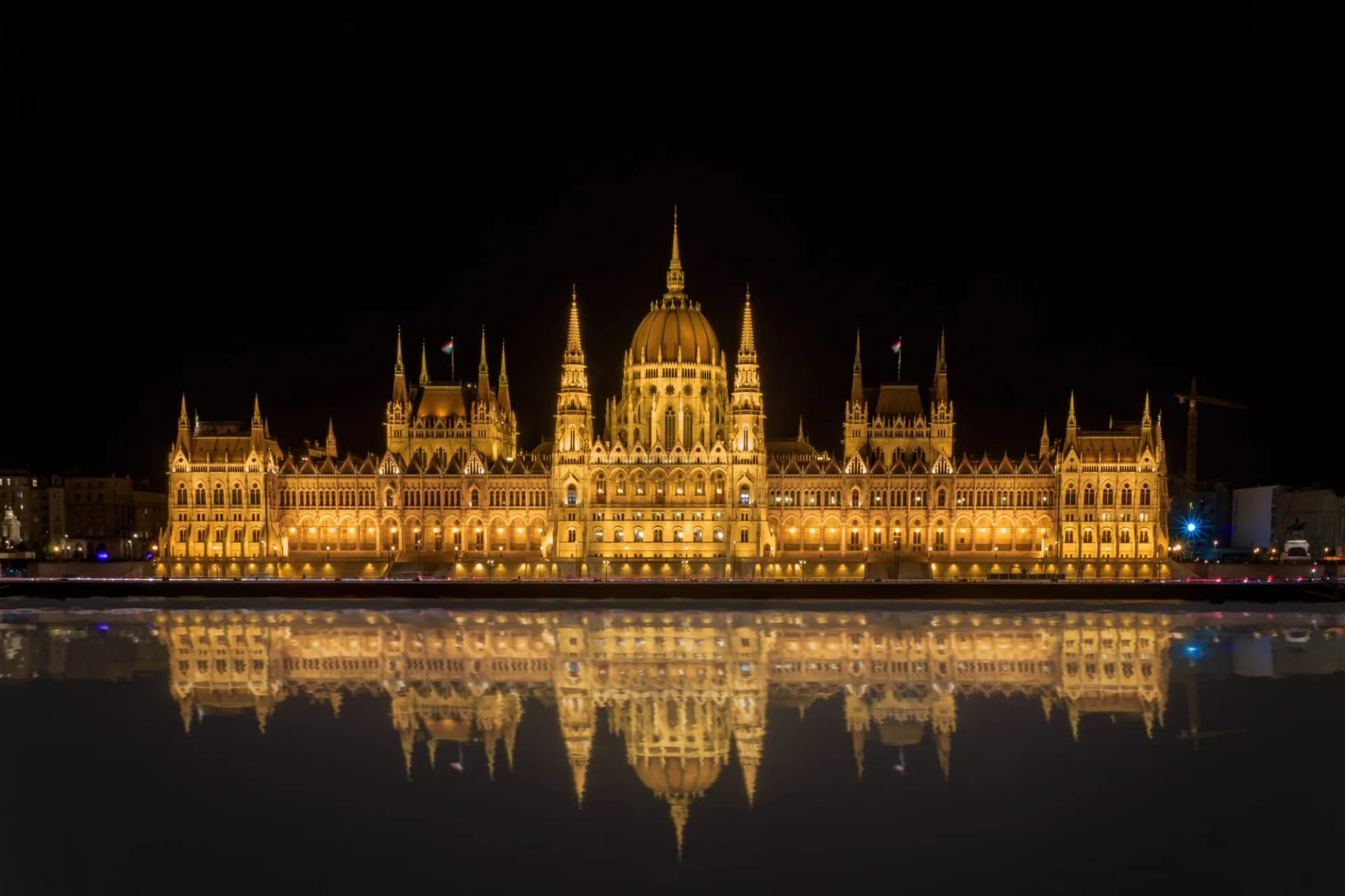 Illuminated Hungarian Parliament Building reflected in water at night