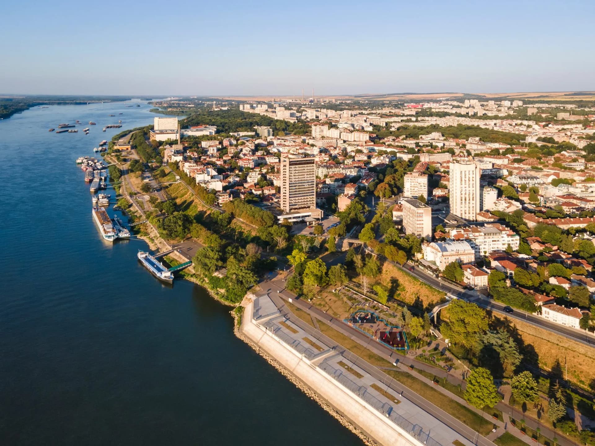 Aerial view of Danube River, docked boats, and the city of Ruse, Bulgaria.