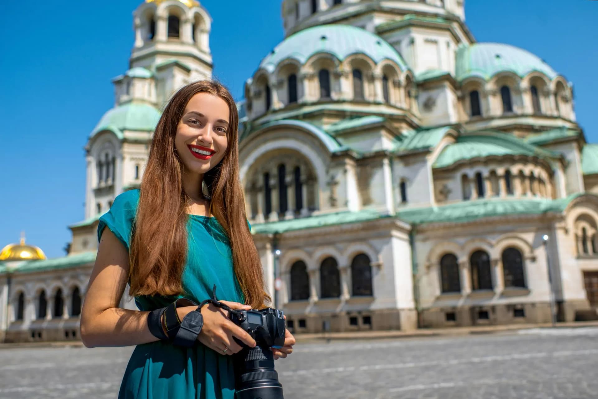 Tourist with camera in front of St. Alexander Nevsky Cathedral in Sofia, Bulgaria.